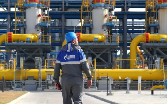 A worker for the Russian state energy company Gazprom surveys a natural gas treatment facility at the starting point of the Nord Stream 2 pipeline in northwest Russia